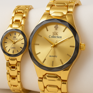 Two gold watches from the ik Collection on a white surface